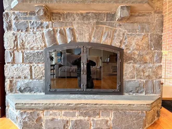 Arched iron doors on a bluestone hearth