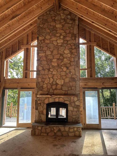 Floor-to-ceiling stone fireplace, finished