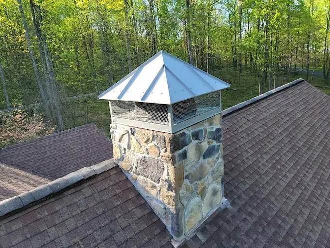Hip-roof cap on a finished stone chimney