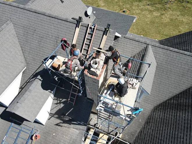 Three technicians, one chimney, seen from above